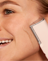 LUXE+ AND SERUM SET - Blush | Image of model using LUXE+ in Blush on her cheek to remove peach fuzz