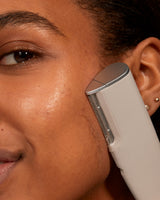 LUXE+ AND SERUM SET - Stone | Image of model using LUXE+  in stone on her cheek to remove peach fuzz