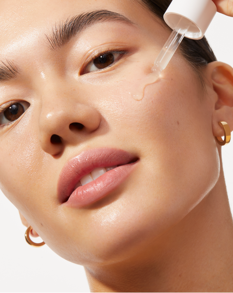 COMPLETE SONIC SKINCARE SET - Stone | model applying ACTIVE COCOONING SERUM to her face from the Complete Sonic Skincare Set in Stone